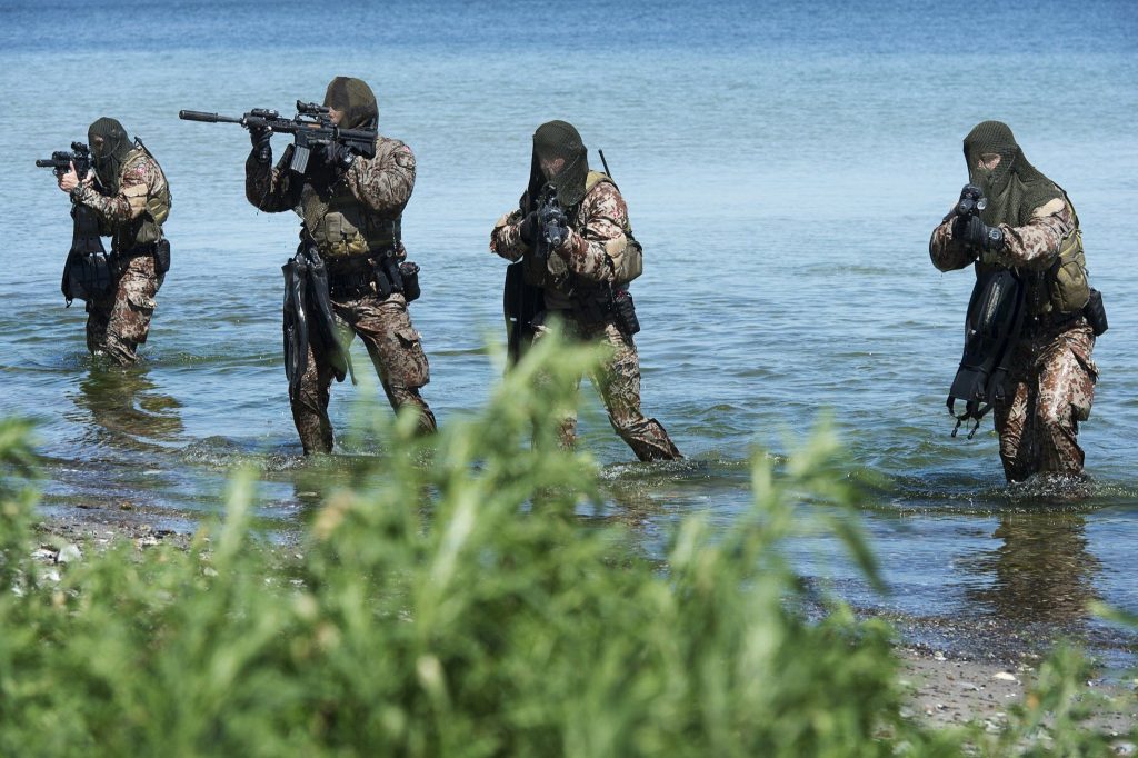 armed danish frogmen standing in water