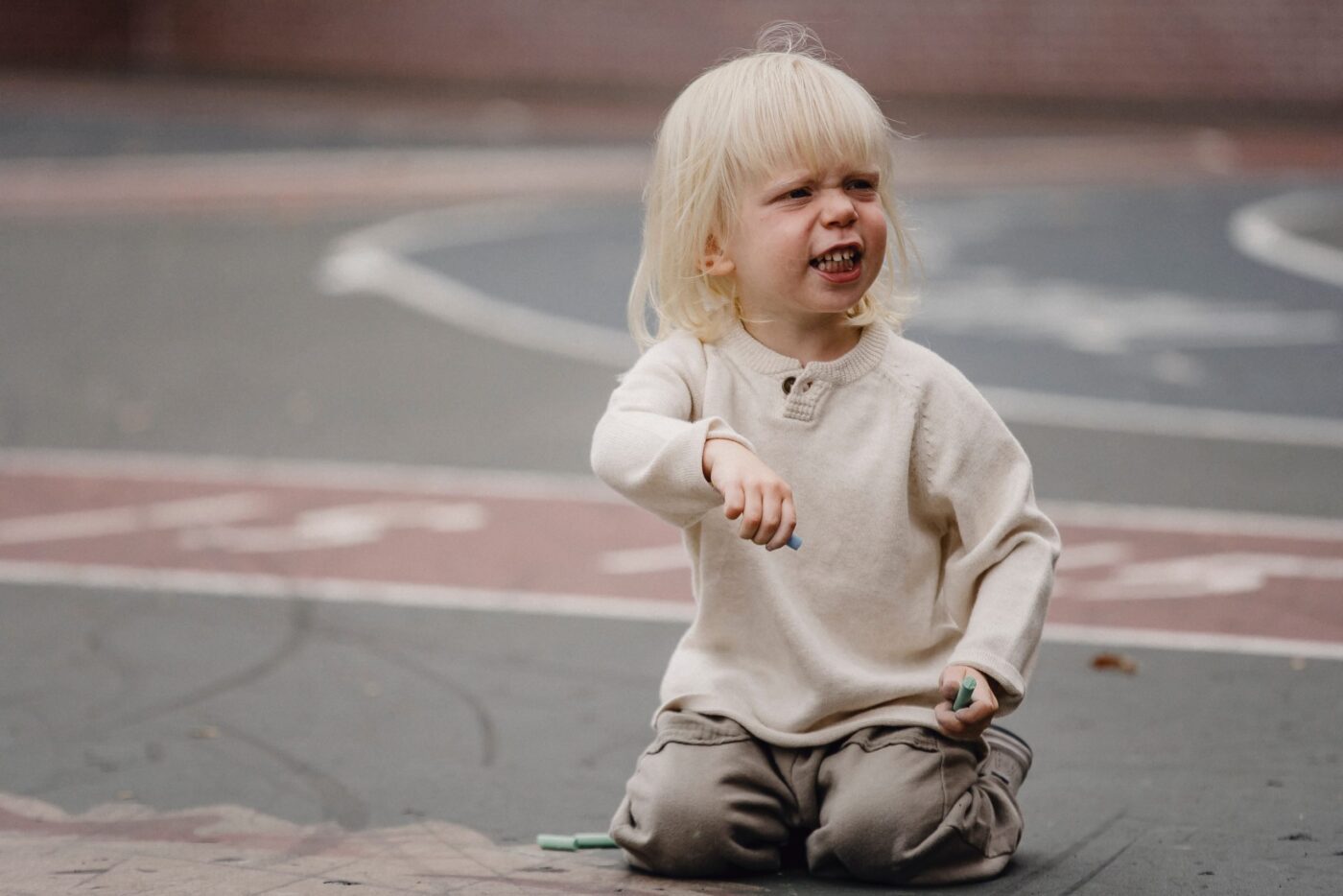 upset toddler on sidewalk