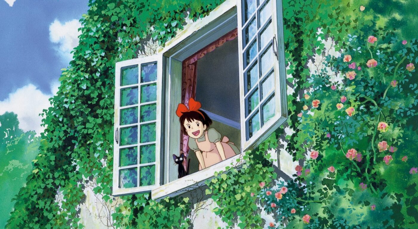 black cat and young girl by an open window
