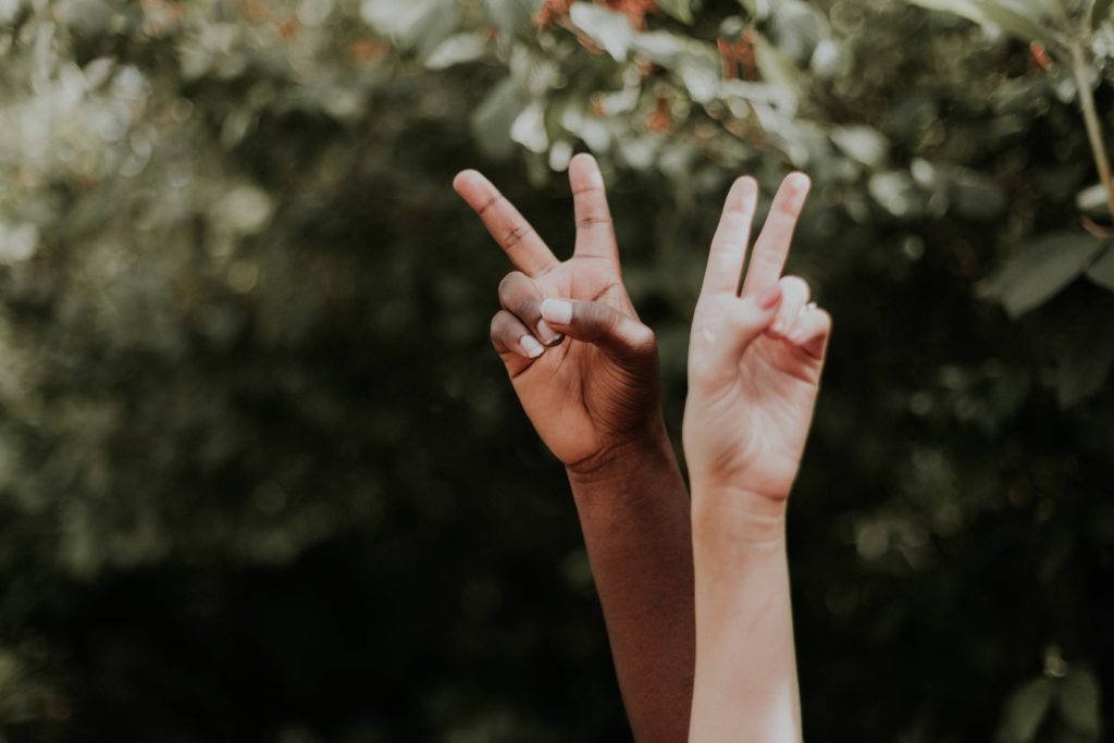 Two hands making a peace sign