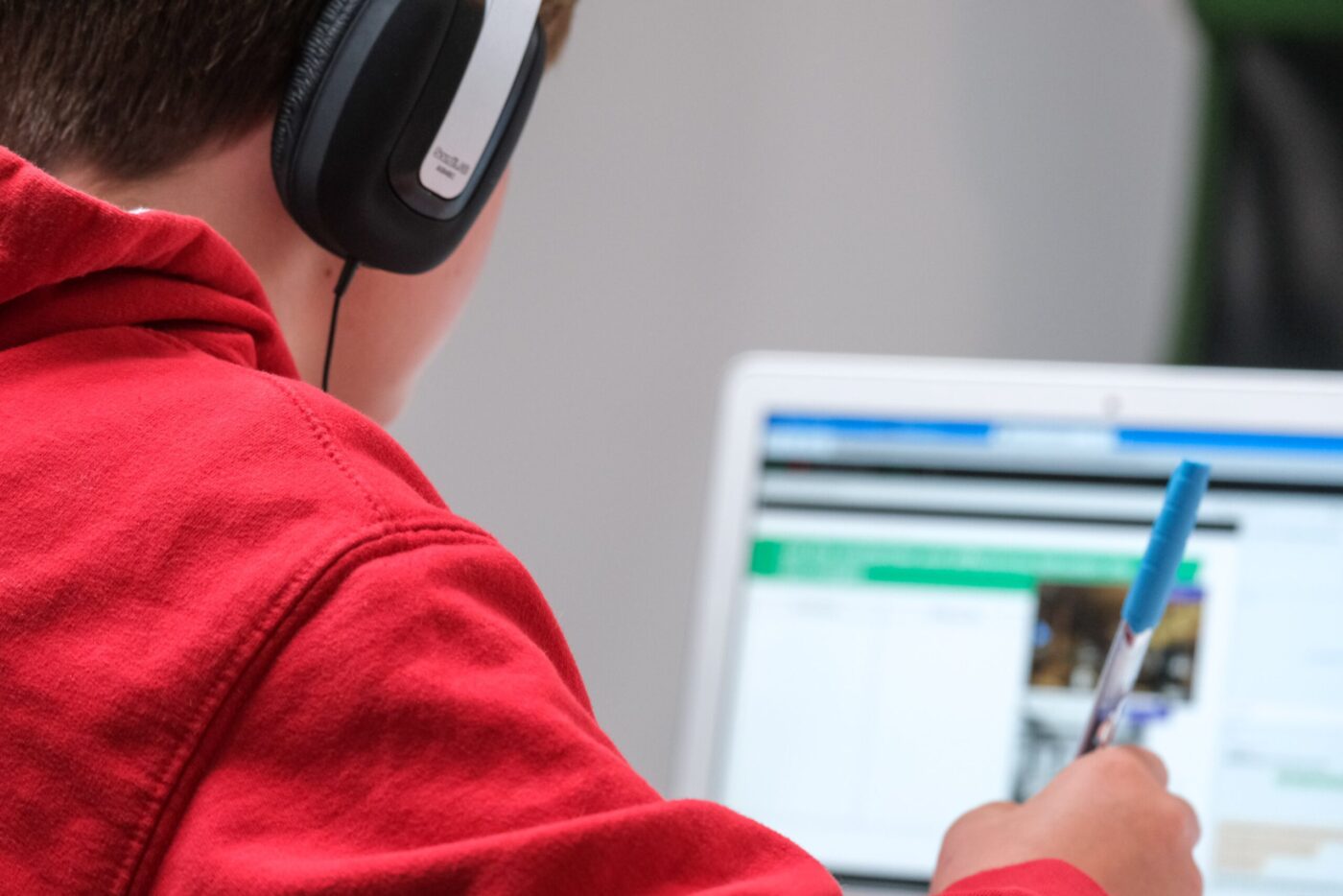 person with headphones working on computer