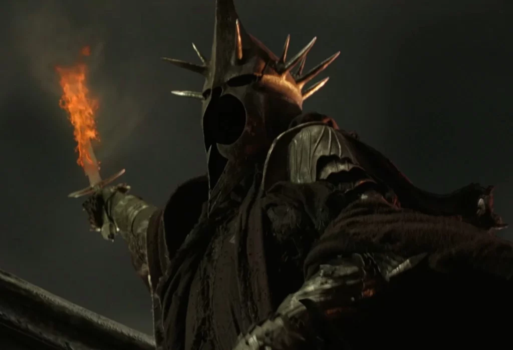 Witch-king holding up a sword