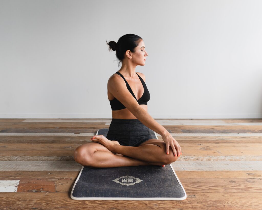 woman sitting on a mat